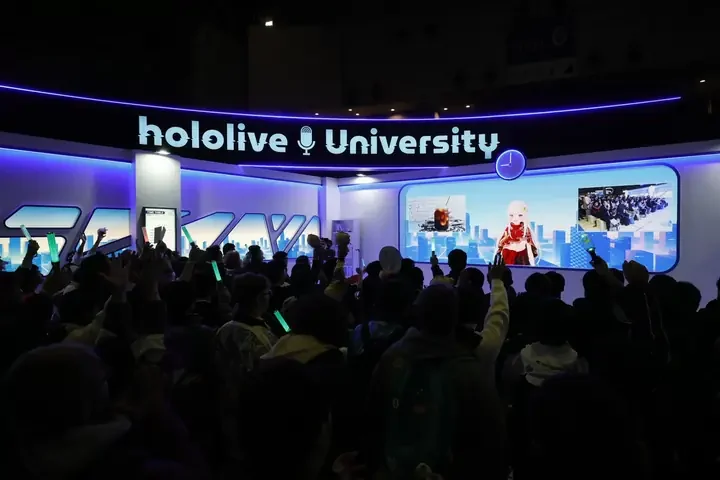 「hololive University」のスクリーン前で手を上げる来場者